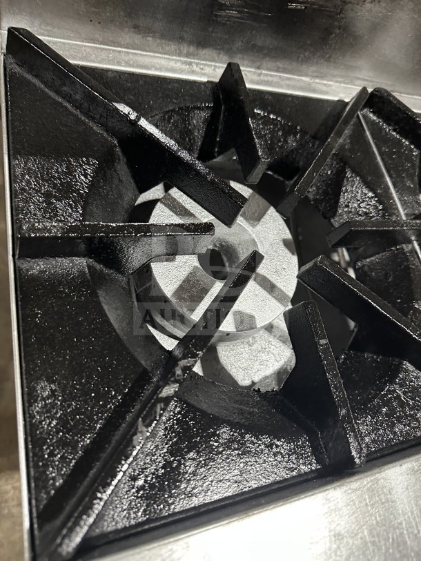 UltraMax stainless steel 6-burner gas hot plate range; close-up of burner; features cast iron grates; commercial use.