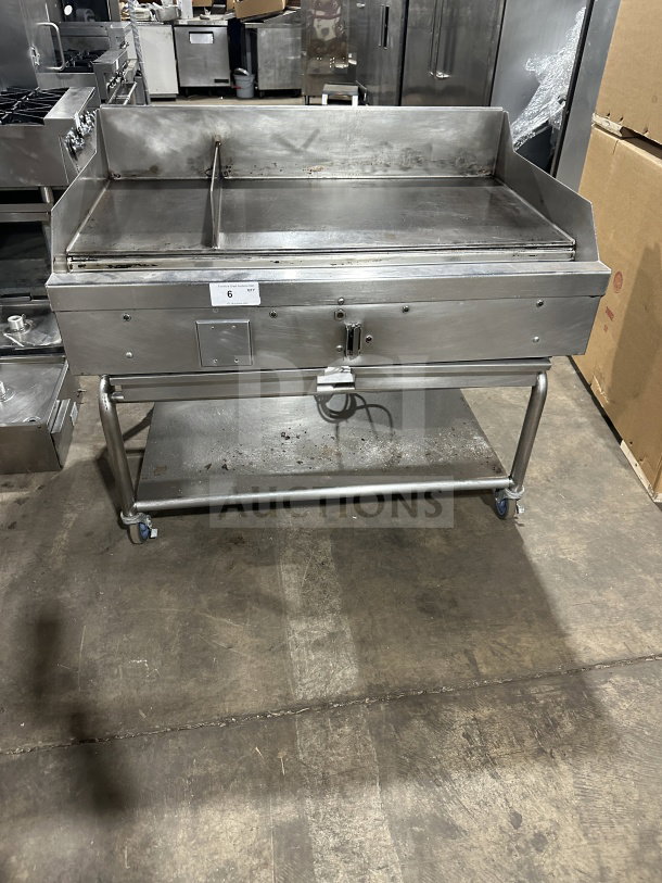 Commercial stainless steel gas griddle with thermostatic control, integrated divider, stand on casters; used condition.
