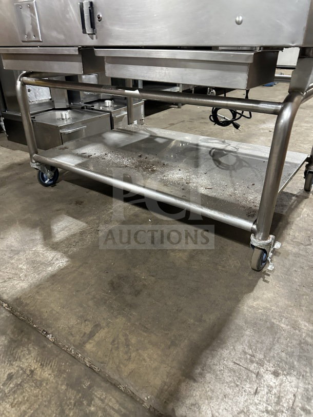 Commercial stainless steel gas griddle with integrated divider and stand on casters. Features thermostatic control.