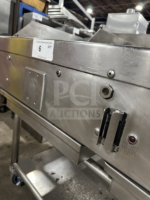 Commercial stainless steel gas griddle with thermostatic controls, integrated divider, stand, and casters. Visible serial markings.
