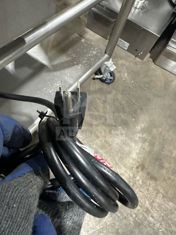 Commercial stainless steel gas griddle with thermostatic controls, integrated divider, and stand on casters; power cord shown.