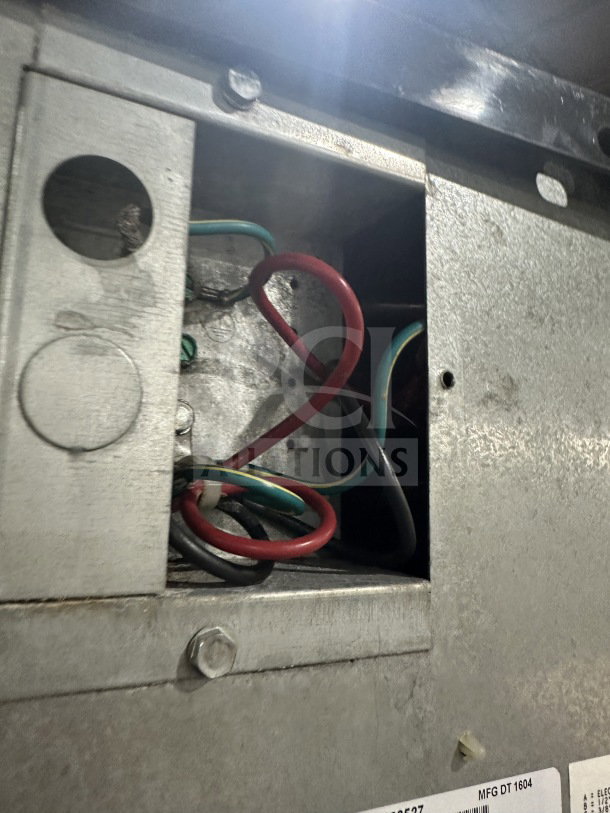 Alt text: Manitowoc Indigo NXT IY1106A-261 ice maker wiring, showing interior wires and metal casing. Model and SN tags visible.