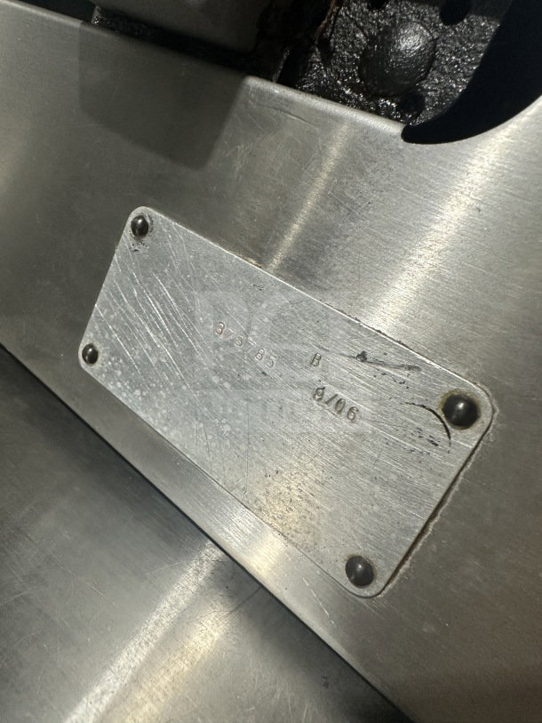 Metallic label on Chefmate Globe Series deli meat slicer, showing serial numbers and detailing, indicating commercial use.