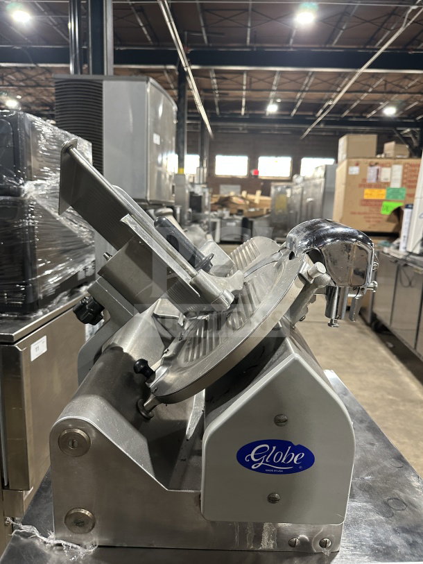 Chefmate Globe Series electric deli meat slicer, used condition, manual gravity feed, on legs, visible branding.