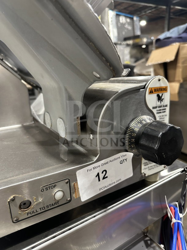 Chefmate Globe Series commercial deli meat slicer, electric-powered, manual gravity feed, on legs, with visible control dial and safety warning.