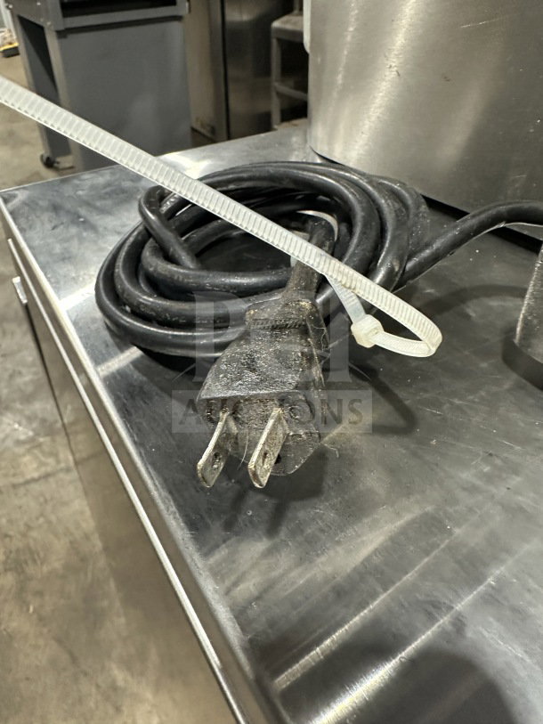 Chefmate Globe Series electric deli meat slicer plug and power cord, displayed on a metal countertop.