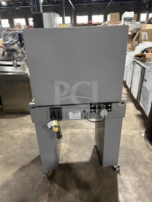 Beseler TD-16-10 shrink wrap system with heat tunnel, grey, 220V, 1 phase, on casters, SN: 061300154, in commercial setting.