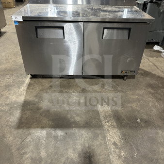 True TWT60 stainless steel 2-door refrigerated worktop table, upturned backsplash, poly-coated rack, on casters, Energy Star certified.