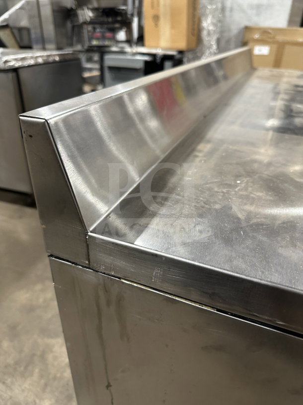 True TWT-60 stainless steel refrigerated worktop table, 2-door, Energy Star certified, up-turned backsplash, on casters.