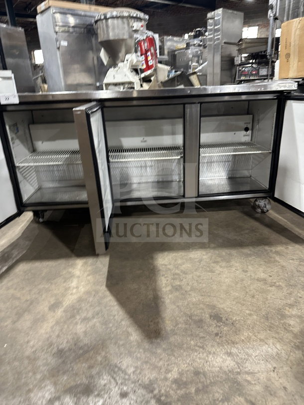 True TUC-72 3-Door Undercounter Refrigerator, stainless steel, poly coated racks, Energy Star, on casters, open doors.
