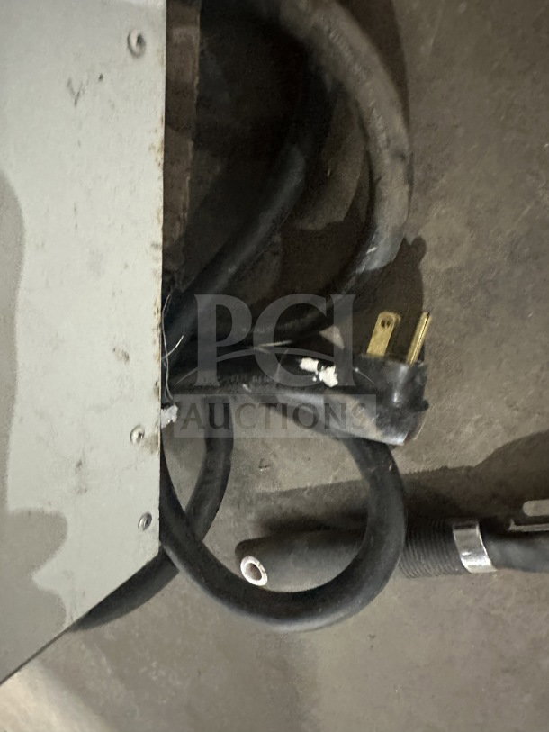 Power cord and parts of the So-Low CA55 low temperature chest freezer, showing external wiring and plug condition.