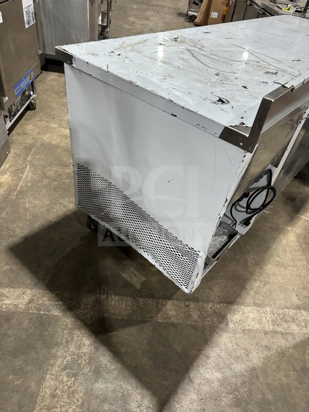 CustomCool LB93SE stainless steel 3-door prep table refrigerator/freezer, electric-powered, on casters, 115V, 1-phase. Visible wear.