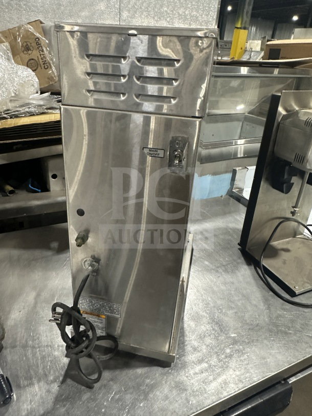 Bunn AXIOM Series stainless steel coffee brewer with hot water dispenser, model AXIOM-DV-APS. Features digital controls, 120V, 1 phase. Visible power cord and main on/off switch. Serial number AXAP007876.