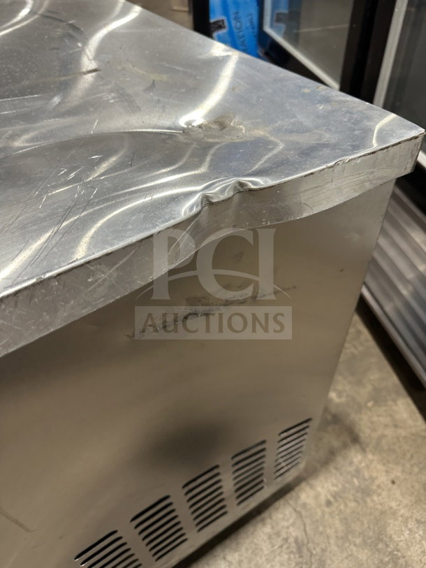 Continental CURB67 stainless steel 2-door lowboy refrigerator/freezer, dented top corner. Model: CURB67, SN: 15052129, on casters.