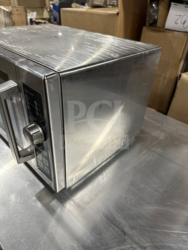 Amana 2023 RCS10DSE stainless steel commercial microwave, electric-powered, excellent condition, 120V, model and serial number visible.