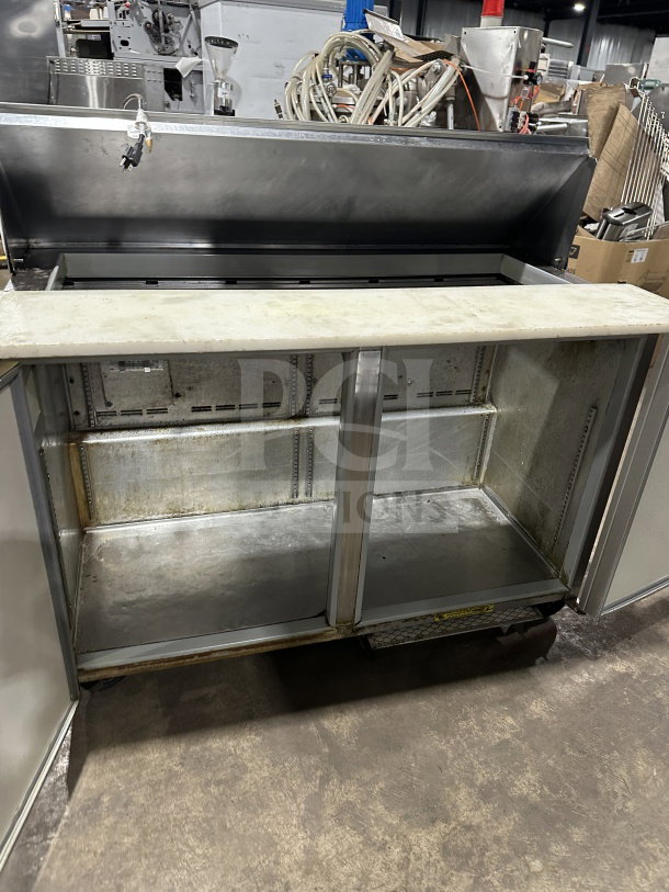 Commercial stainless steel 2-door refrigerated prep table with cutting board, on casters, for sandwiches/salads.