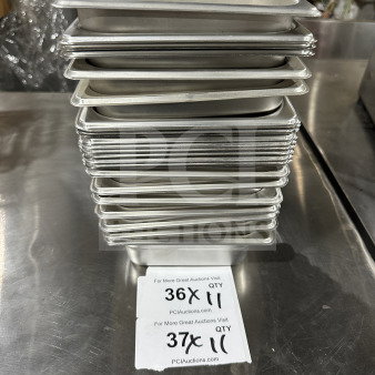 Stack of Thunder Group stainless steel 1/9 size steam table pans, model STPA3192, in good condition with quantity tags.