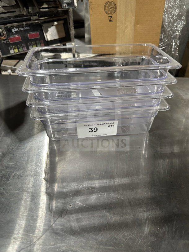 Winco SP7304 commercial clear polycarbonate 1/6-size food pan, stacked, in excellent condition, auction label "39".