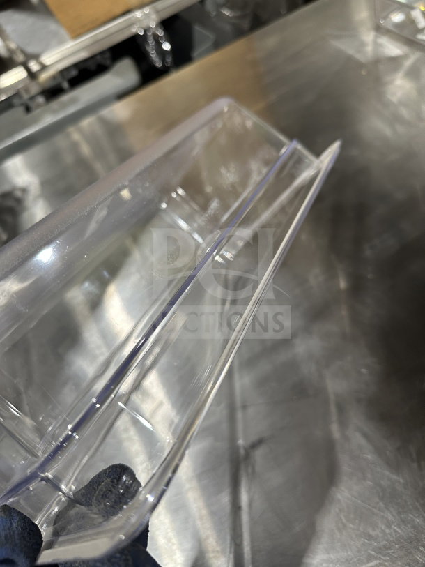 Winco SP7304 commercial food pan in clear polycarbonate, 1/6-size. New condition, durable and transparent for easy content viewing.
