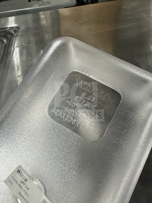 Winco SP7304 commercial clear polycarbonate 1/6-size food pan, sturdy build, labeled with temperature range and dimensions.