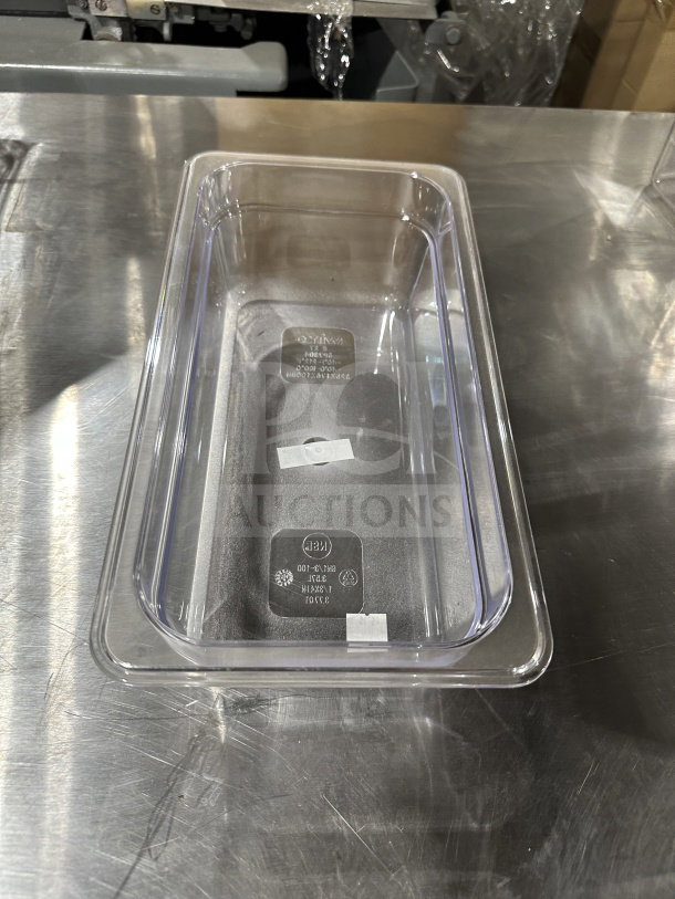 Winco SP7304 1/6-size clear polycarbonate food pan, commercial grade, used condition, visible model markings inside.