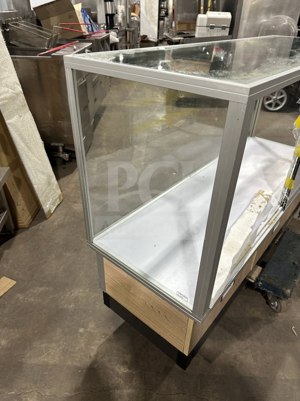 Commercial full glass dry bakery display case with wood grain trim, excellent condition, sturdy metal frame, ideal for showcasing.