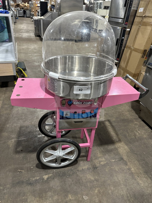 Olde Midway Spin-2000 hot-pink cotton candy machine/cart with stainless steel bowl, clear dome lid. Model: CONCOTSP2000CRT.