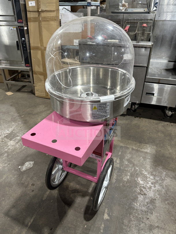 Olde Midway Spin-2000 pink electric cotton candy machine, stainless steel bowl, clear dome lid, on wheels, model CON-COT-SP2000-CRT.