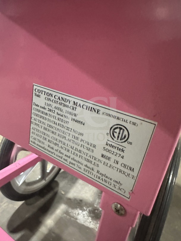 Olde Midway Spin-2000 cotton candy machine in hot pink. Features stainless steel bowl, clear dome, wheels. Model: CONCOTSP2000CRT.
