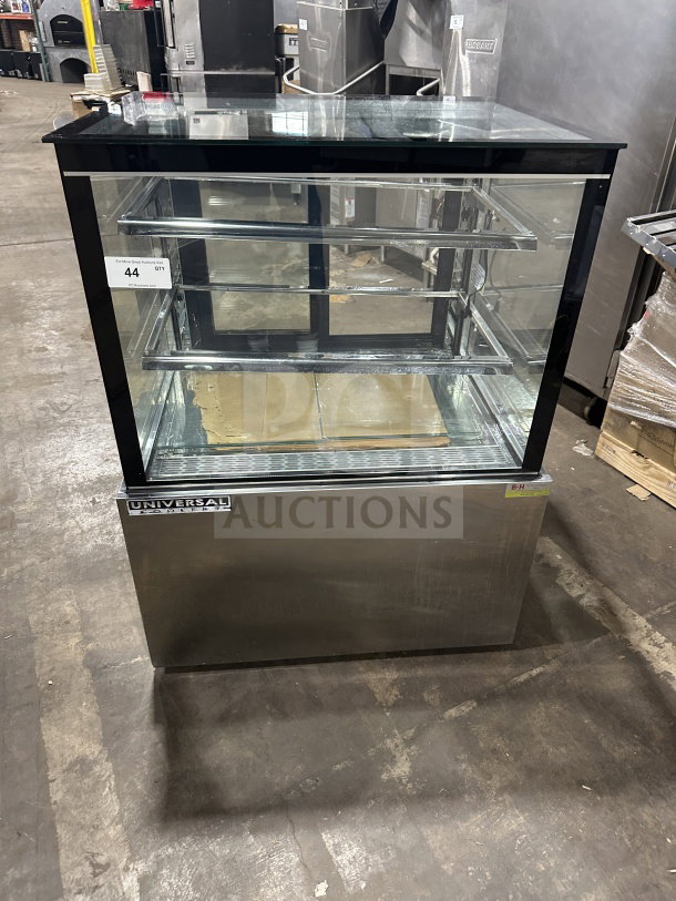 Universal CD9002HC refrigerated bakery display, stainless steel, straight glass, sliding rear doors, 115V, excellent condition.