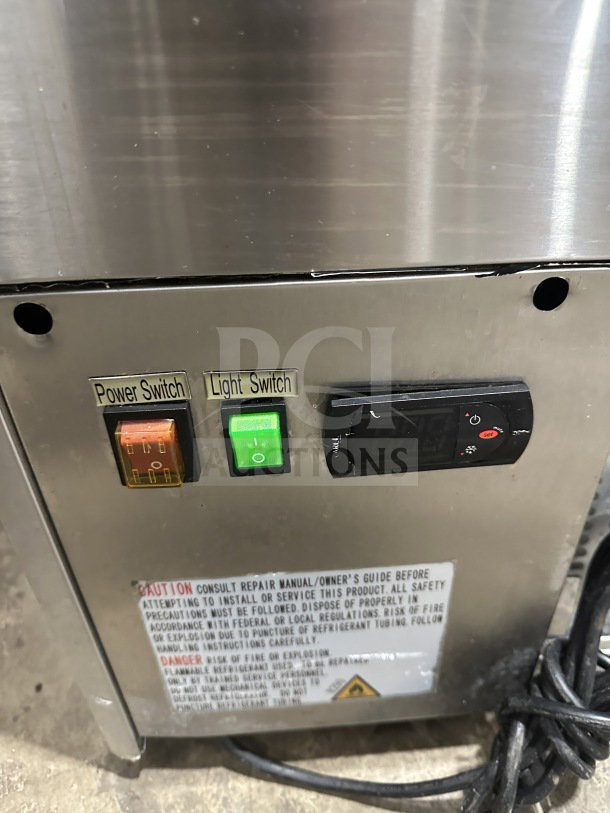 Universal refrigerated bakery display model CD9002HC controls close-up, featuring power switch, light switch, and digital settings.