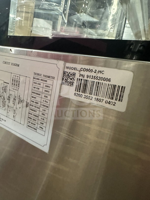 Universal CD9002HC stainless steel refrigerated bakery display with straight glass. Features rear sliding doors, 115V. Serial number 6260355218070402 visible.