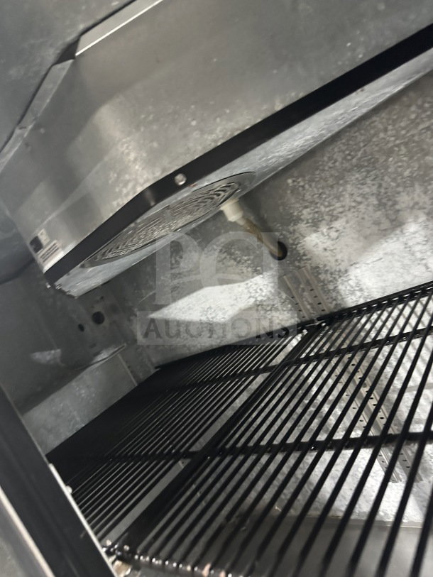 True stainless steel 2-door back bar cooler, model TBB-24-48S, with black coated wired rack, solid interior view.
