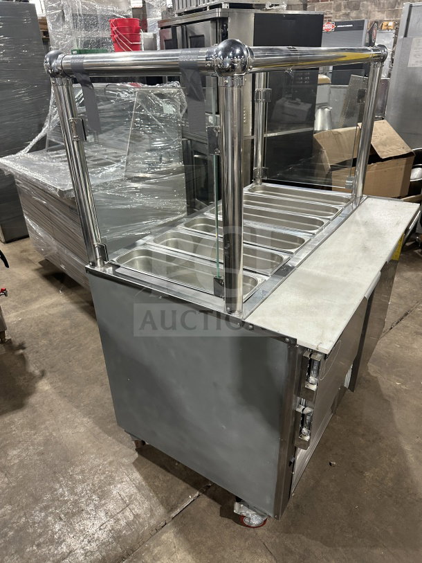Leader stainless steel mobile refrigerated salad bar with glass top and casters, excellent condition, for commercial use.