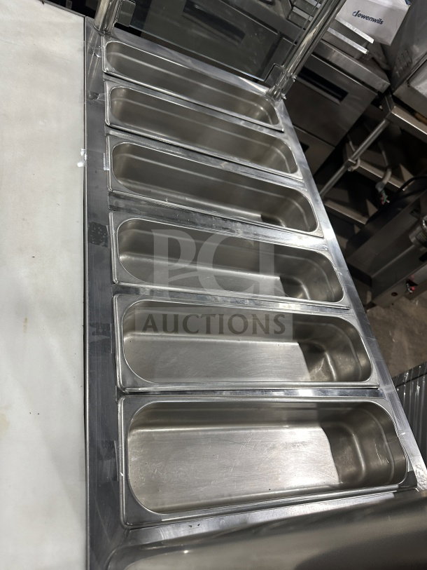 Leader Commercial stainless steel mobile refrigerated salad bar with glass top, 6 pan capacity, on casters, excellent condition.