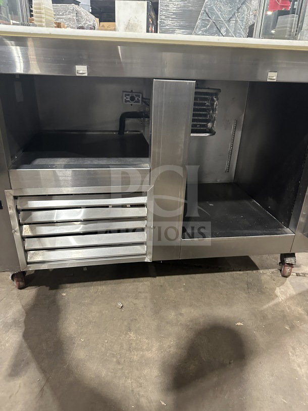 Leader stainless steel refrigerated salad bar station on casters, used condition, featuring multiple compartments.