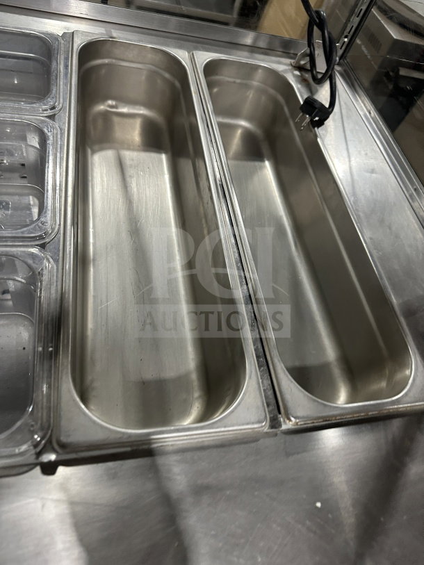 Leader refrigerated salad bar with stainless steel pans, full-glass sneeze guard, and visible power cord. Clean condition.