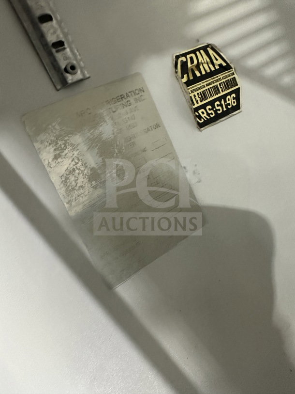 National Refrigeration 14S-96 model label and CRMA sanitation standard sticker inside the commercial glass freezer.
