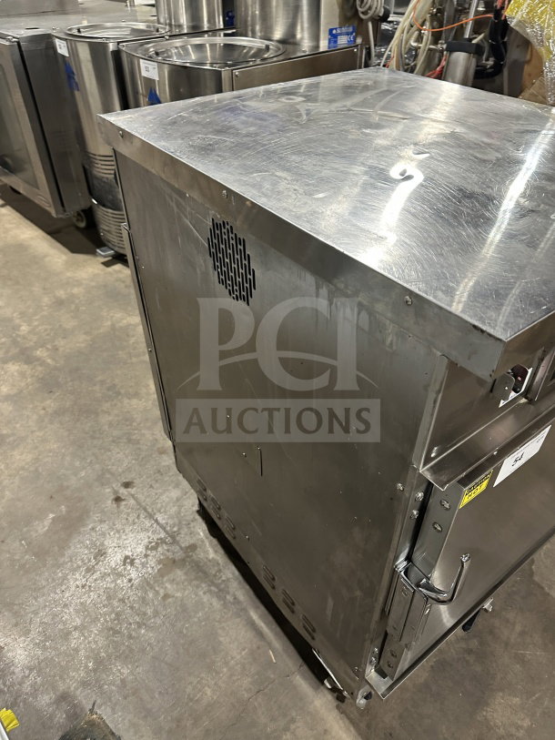 Winston Industries CVap Silver Edition stainless steel electric half-size undercounter oven, model CAT509GJ, on casters.