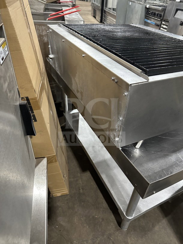 Radiance 36" stainless steel gas char broiler, cast iron grates, individual controls, on legs and stand.