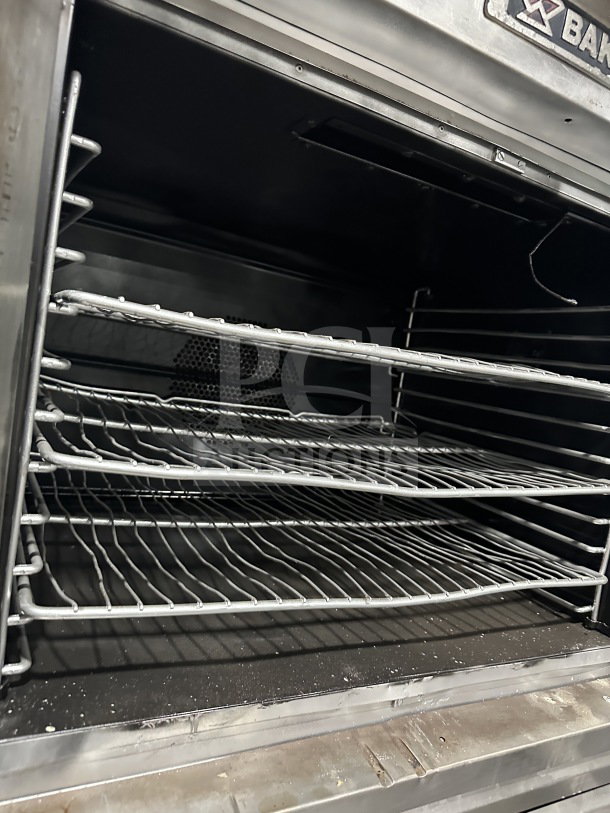 Bakers Pride Cyclone Series stainless steel double-stacked convection oven, model CO11G1, with wired oven rack, on casters.