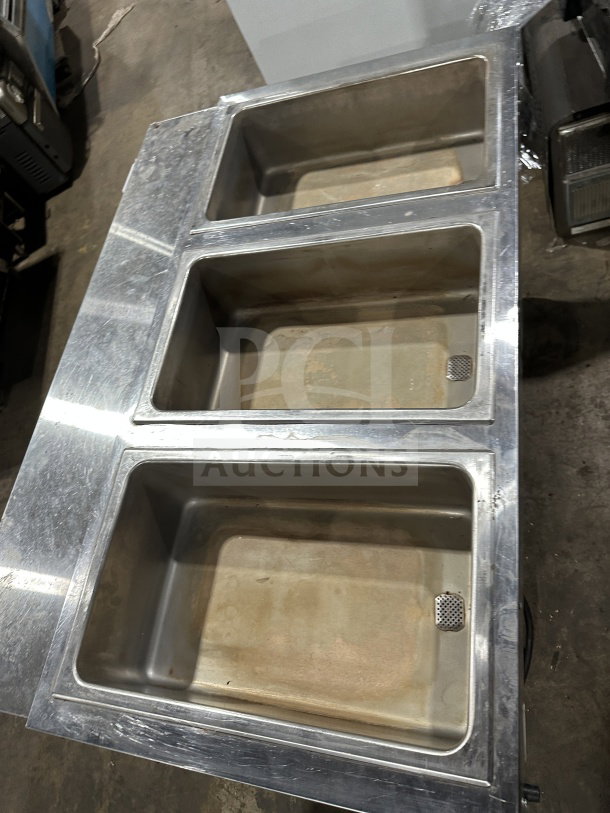 Eagle Group stainless steel underbar cocktail/ice bin on legs, featuring a three-bin design. Used condition with surface wear.
