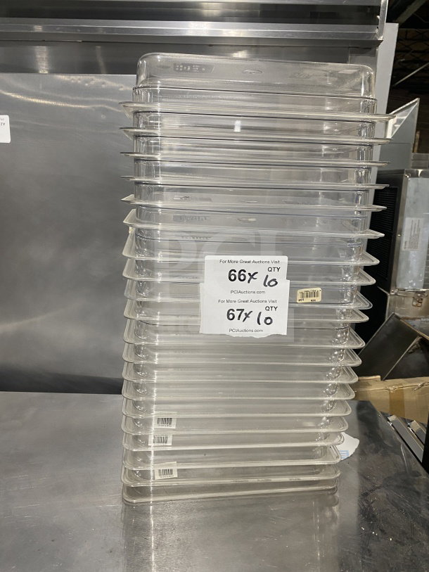 Stack of Cambro 6311 full-size translucent polypropylene food pans. Excellent condition with auction labels visible.