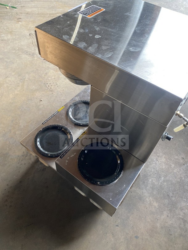 Bunn AXIOM 06 TWIN stainless steel coffee brewer, six warming plates, hot water dispenser, visible wear, model details on top.