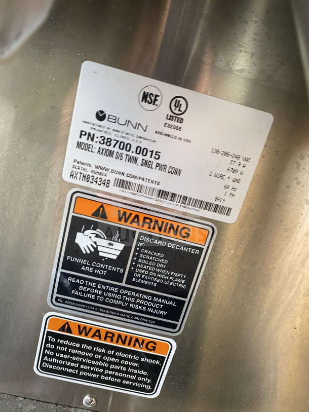 Bunn AXIOM 06 TWIN commercial coffee brewer labels, showing model number, warnings, and electrical specifications.