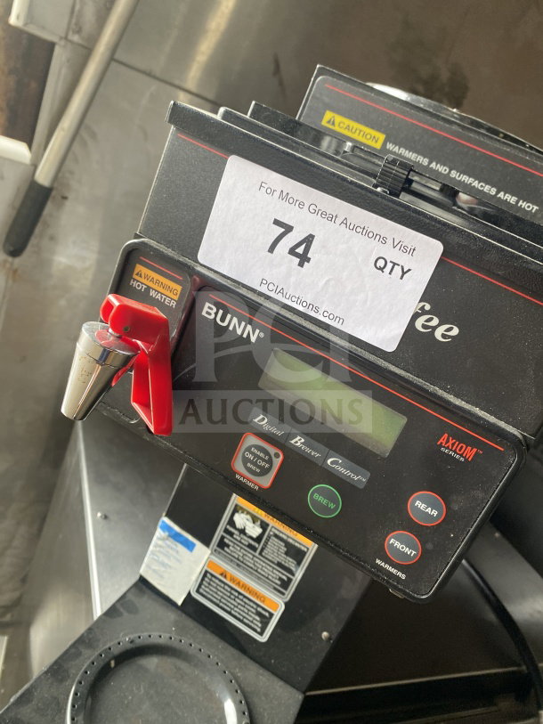Bunn AXIOMP353 commercial coffee machine with 3 warming stations, digital controls, caution labels, and auction tag.