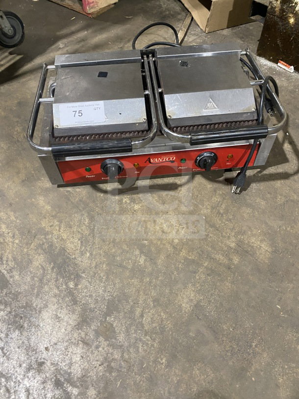 Avantco stainless steel electric double countertop panini grill with grooved cast iron plates, red control panel, visible wear.
