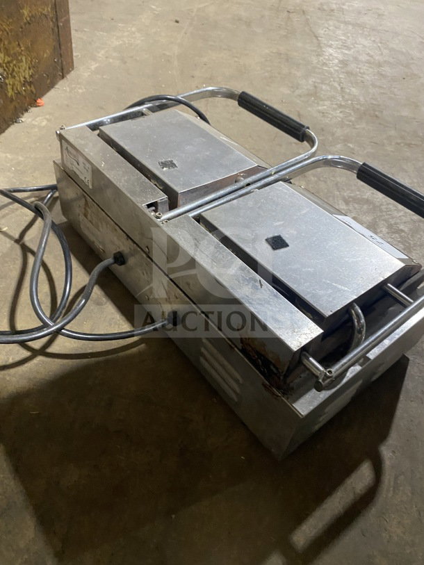 Avantco commercial electric double countertop panini grill with stainless steel body and grooved cast iron plates, used condition.