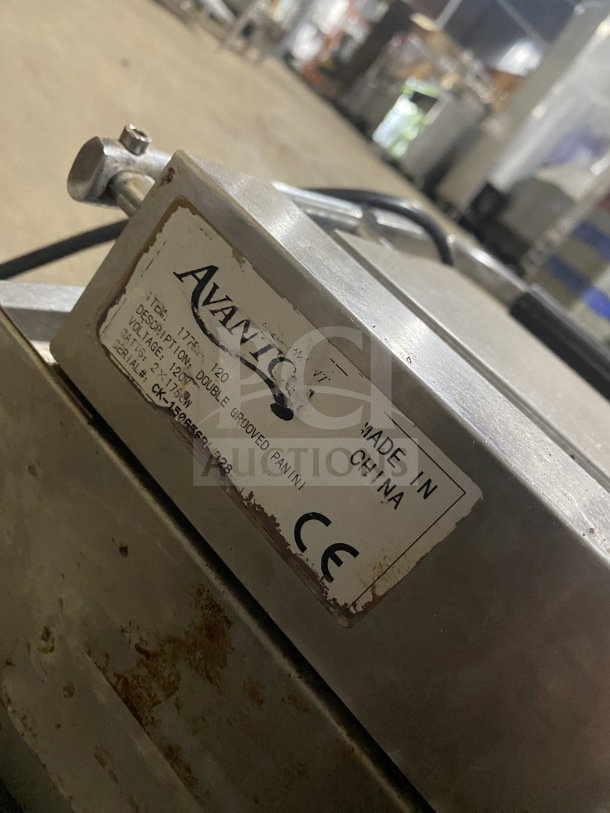 Avantco commercial stainless steel double countertop panini grill with grooved cast iron plates, slightly worn. Made in China.