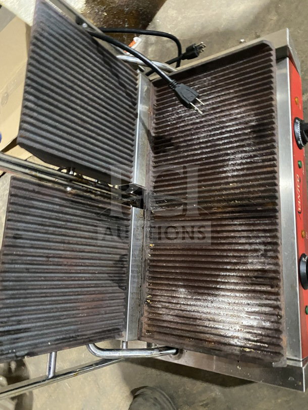 Avantco stainless steel electric double countertop panini grill with grooved cast iron plates, used condition, visible wear.